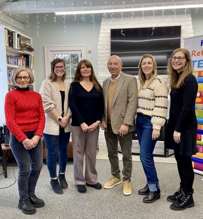 6 people standing in library