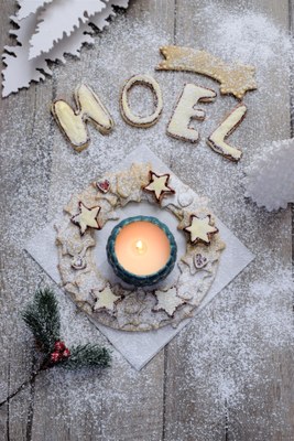 wreath made of star shaped cookies with a candle