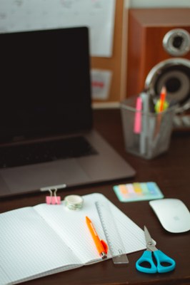 Computer with school supplies at the front